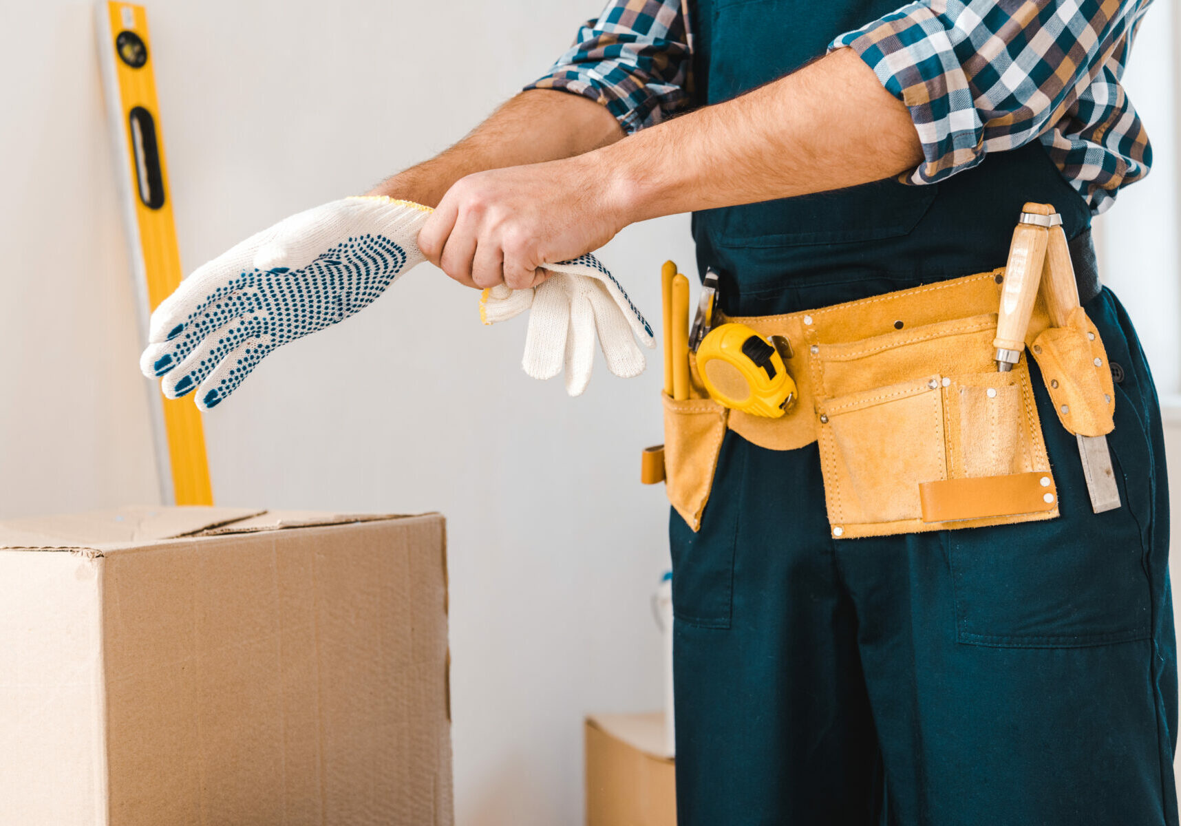cropped view of handyman wearing glove on hand
