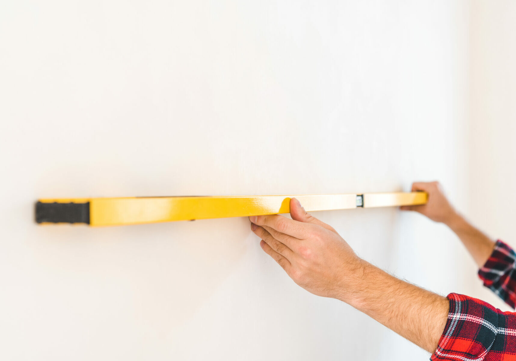 cropped view of man measuring wall at home